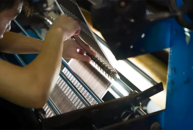 Worker Operating Industrial Printing and Cutting Machine